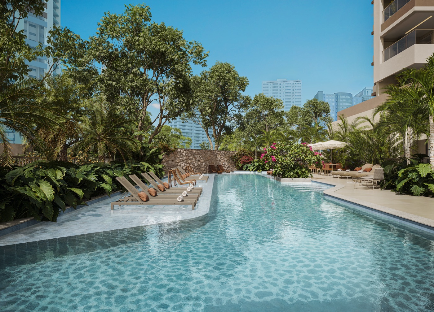 Piscina externa do Kronos by Tegra, cercada por paisagismo e espreguiçadeiras, na Barra da Tijuca